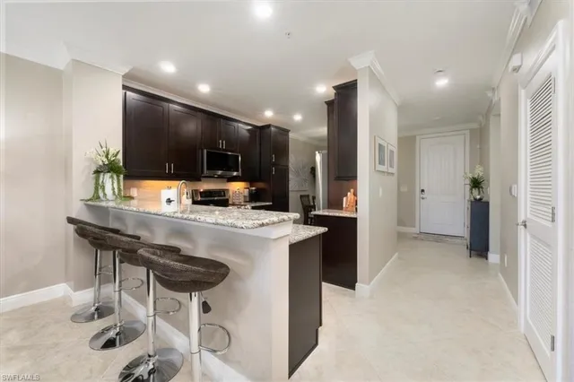 a view of a kitchen with a sink and a refrigerator