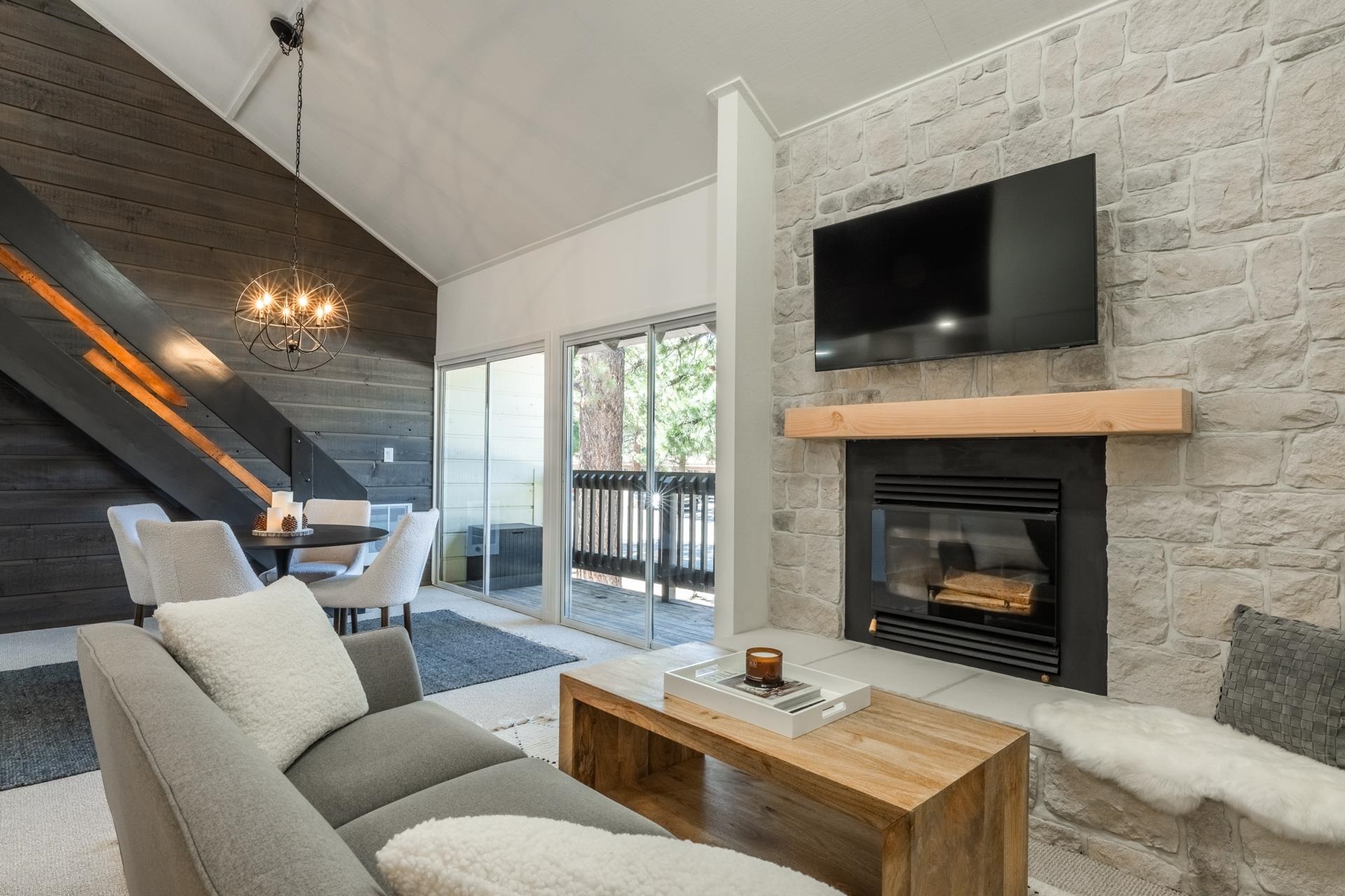 a living room with furniture a flat screen tv and a fireplace