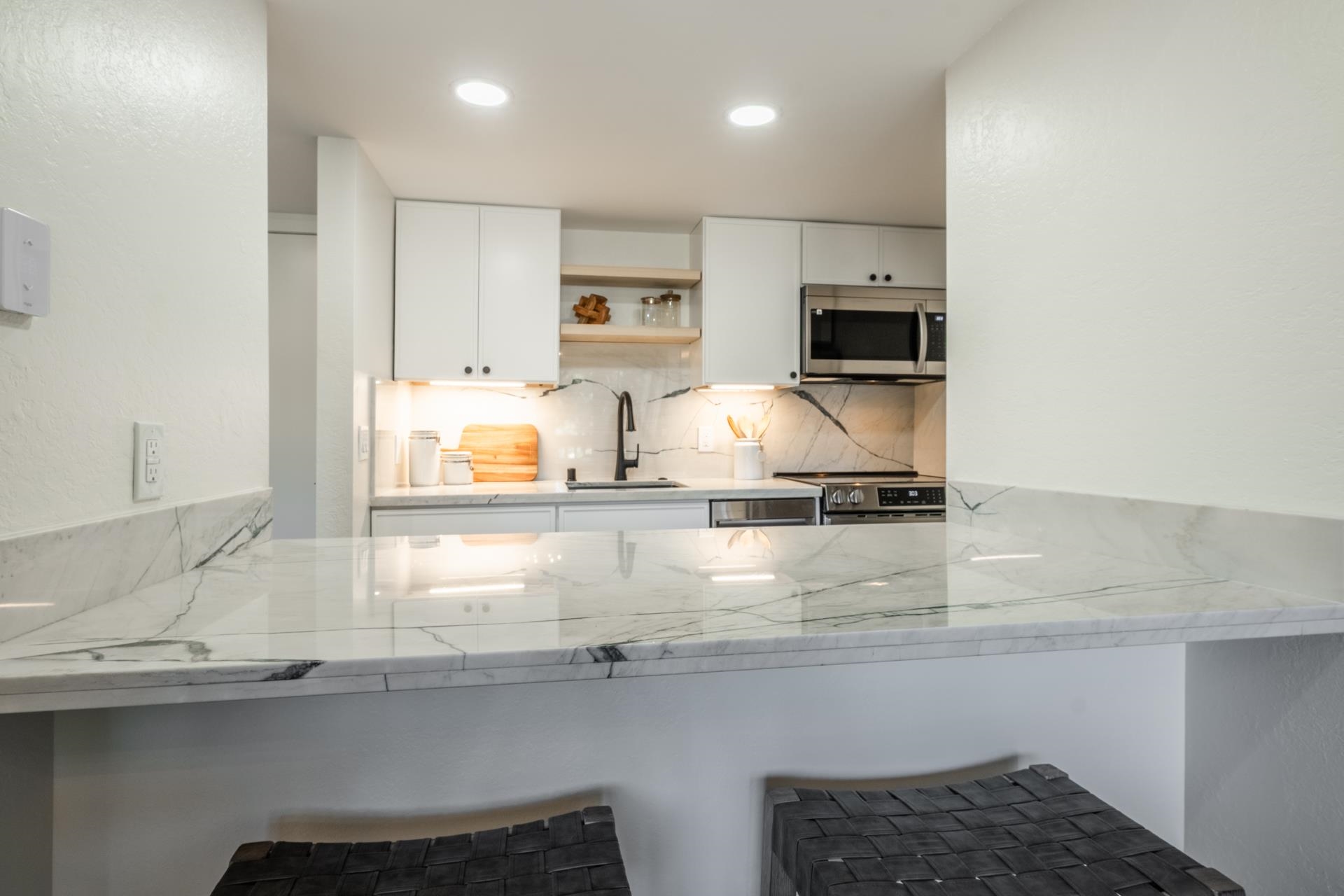 2289 Sierra Nevada Road, Unit F15 Mammoth Lakes, CA 93546 - Photo 13 of 44 a kitchen with kitchen island granite countertop a sink a stove and a microwave