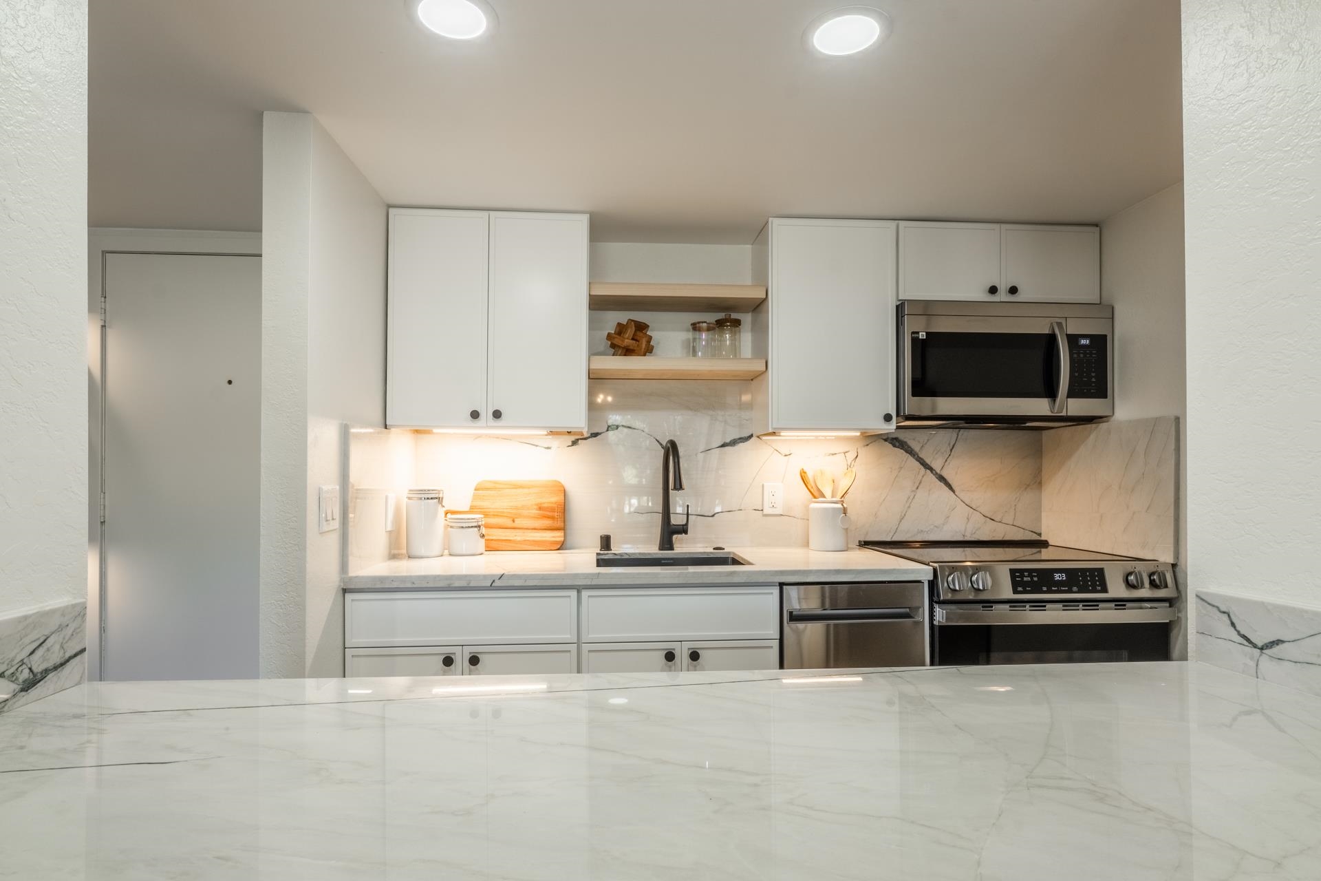 2289 Sierra Nevada Road, Unit F15 Mammoth Lakes, CA 93546 - Photo 14 of 44 a kitchen with stainless steel appliances a stove a microwave and cabinets