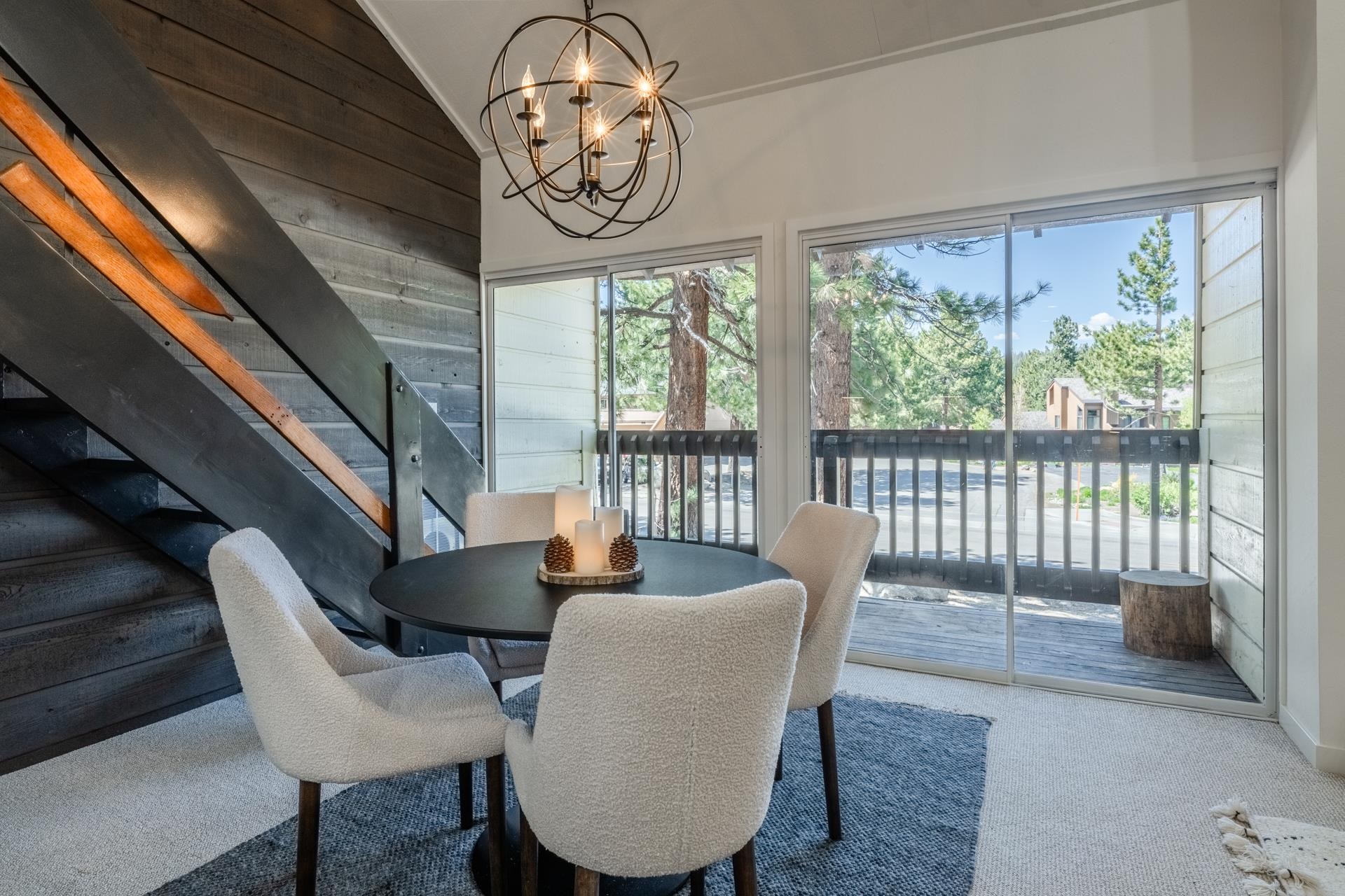 2289 Sierra Nevada Road, Unit F15 Mammoth Lakes, CA 93546 - Photo 20 of 44 a view of a dining room with furniture a chandelier and wooden floor