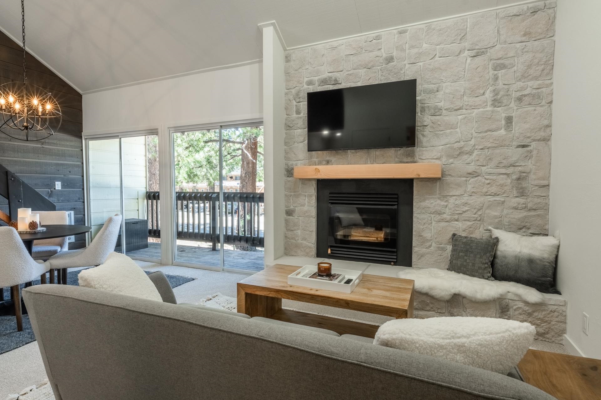 2289 Sierra Nevada Road, Unit F15 Mammoth Lakes, CA 93546 - Photo 2 of 44 a living room with furniture a fireplace and a flat screen tv