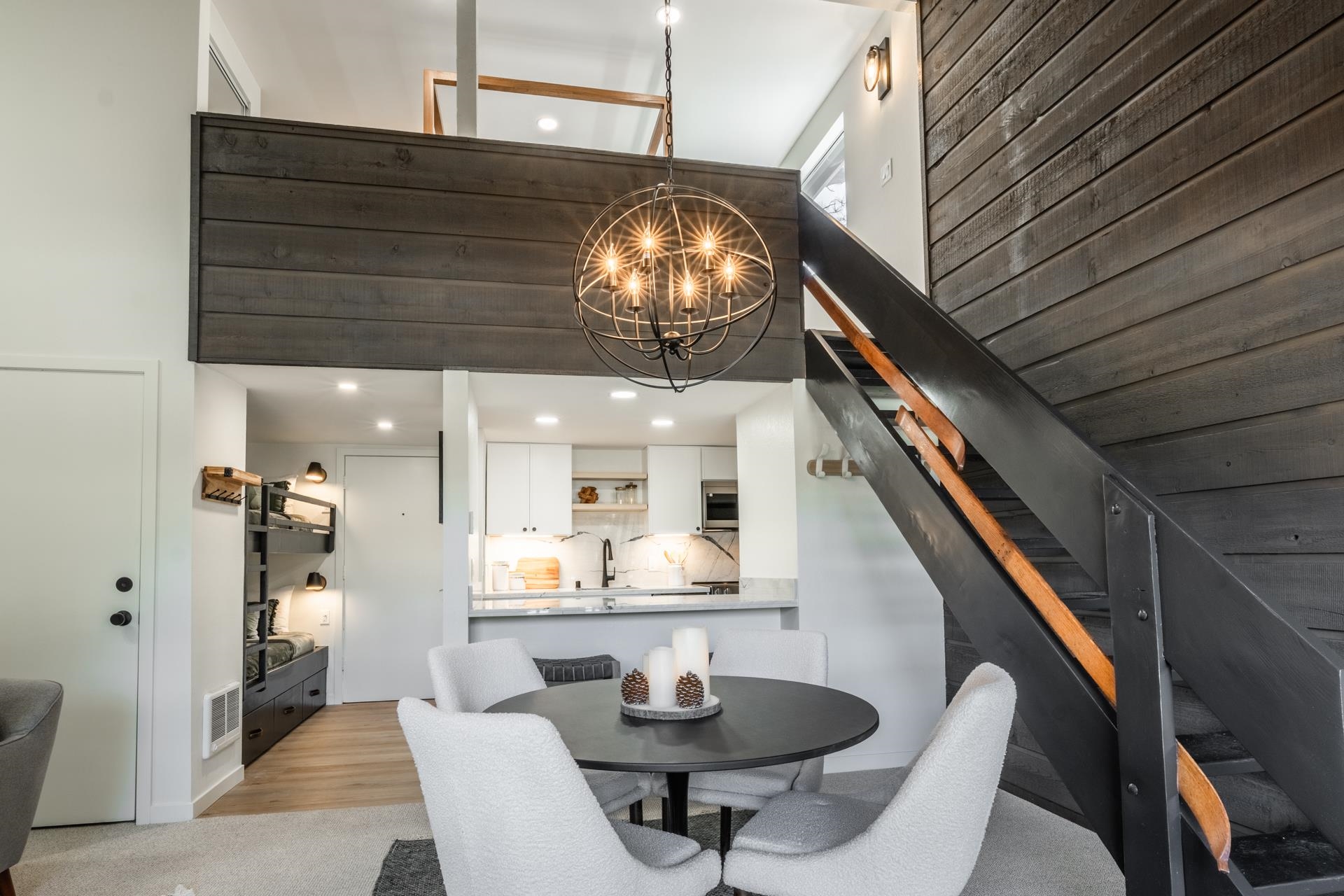 2289 Sierra Nevada Road, Unit F15 Mammoth Lakes, CA 93546 - Photo 24 of 44 a dining room with wooden floor a chandelier a wooden table and chairs