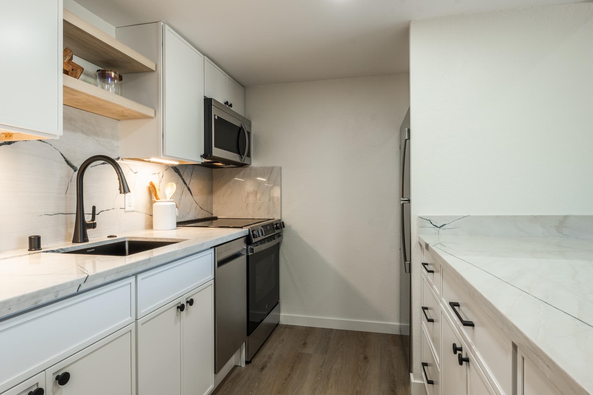 2289 Sierra Nevada Road, Unit F15 Mammoth Lakes, CA 93546 - Photo 9 of 44 a kitchen with stainless steel appliances granite countertop a sink and a stove top oven