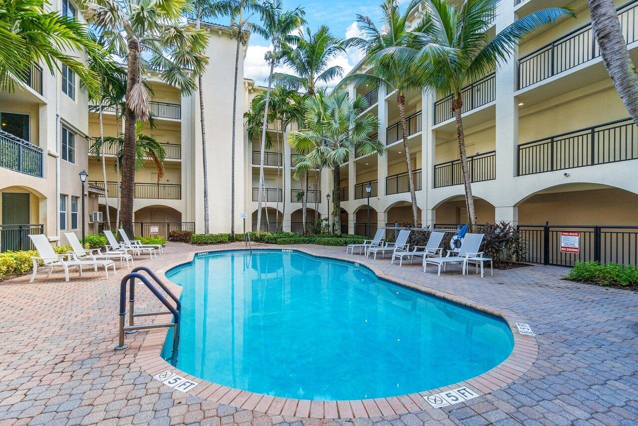 1 Renaissance Way, Unit 416 Boynton Beach, FL 33426 - Photo 17 of 31 a view of a swimming pool with a lounge chair