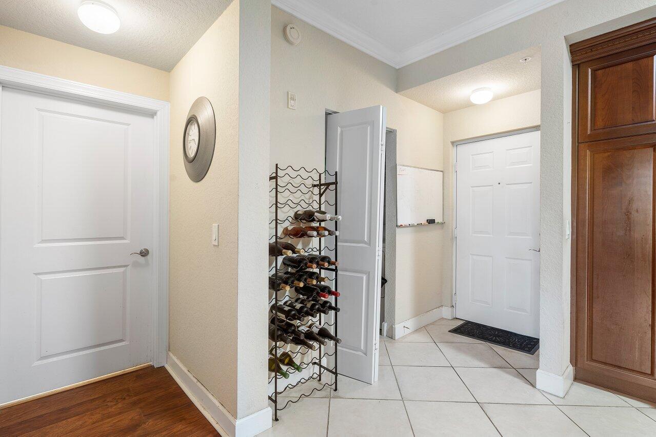 1 Renaissance Way, Unit 416 Boynton Beach, FL 33426 - Photo 2 of 31 a view of a hallway with entryway wooden floor and front door