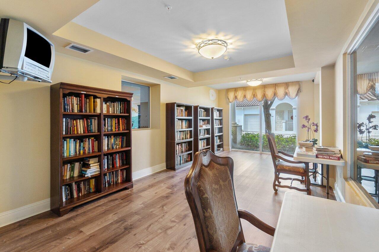 1 Renaissance Way, Unit 416 Boynton Beach, FL 33426 - Photo 22 of 31 a living room with furniture and a book shelf