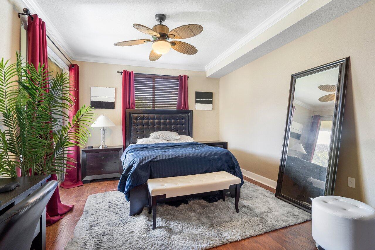 1 Renaissance Way, Unit 416 Boynton Beach, FL 33426 - Photo 8 of 31 a bedroom with a bed and a chandelier
