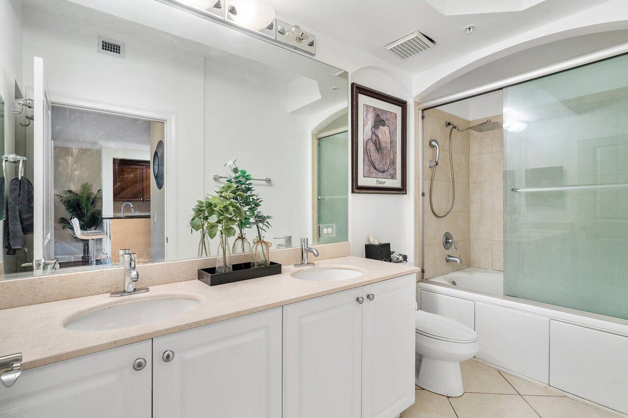 1 Renaissance Way, Unit 416 Boynton Beach, FL 33426 - Photo 10 of 31 a bathroom with a granite countertop sink toilet and shower
