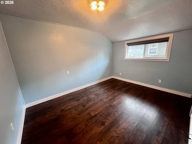 a view of wooden floor and windows in a room