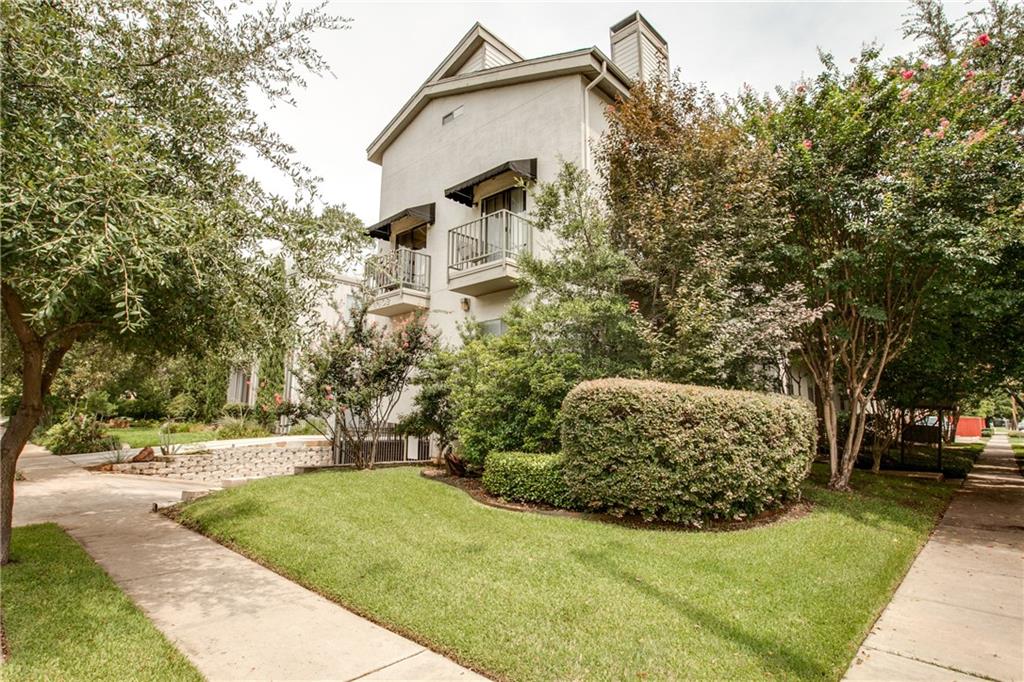 a view of a street with a building in the background