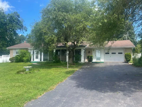 a front view of a house with a yard and porch