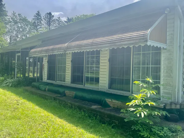 a view of an house with outdoor space and yard
