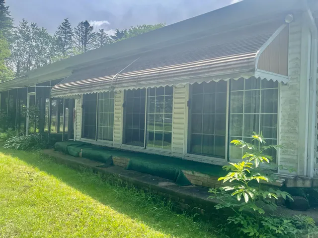 a view of an house with outdoor space and yard