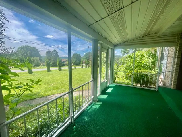 a kitchen with granite countertop white cabinets and refrigerator