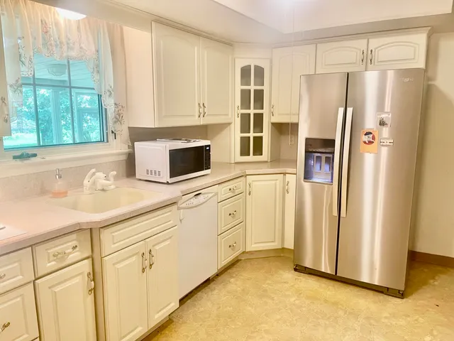 a kitchen with stainless steel appliances a stove microwave and refrigerator