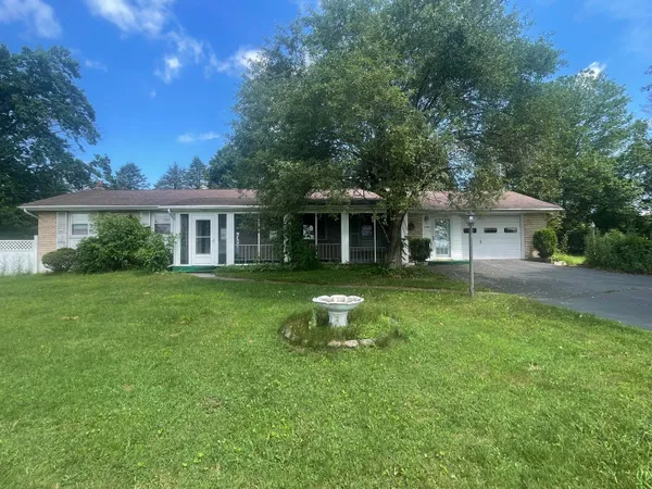a front view of a house with a garden