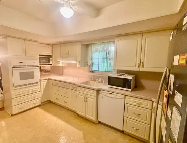 a kitchen with white cabinets and a sink