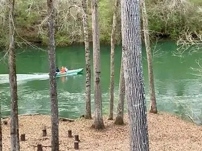 a bed sitting in a bedroom next to a lamp and a lamp