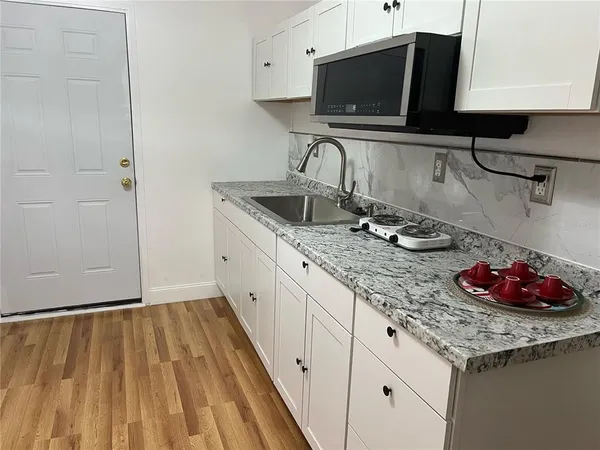 a kitchen with a sink and cabinets