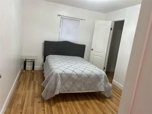 a bed sitting in a bedroom next to a wooden door