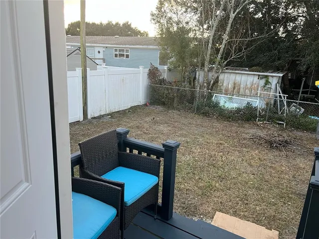 a wooden bench sitting in backside of a house