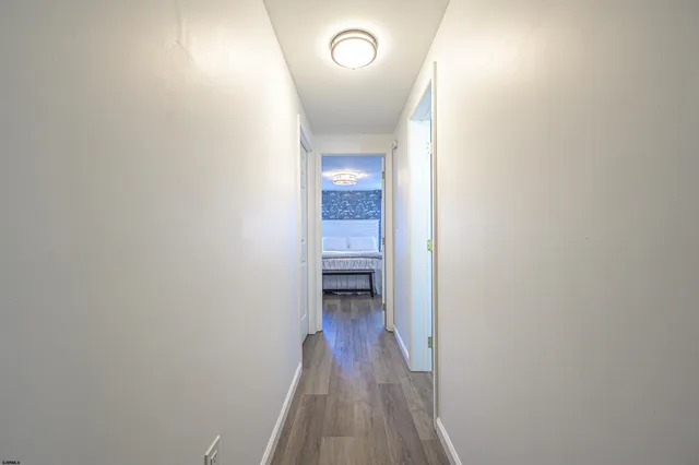 a view of a hallway with wooden floor