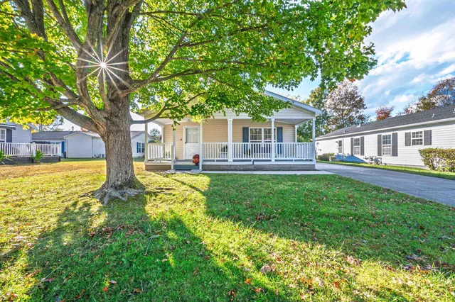 a house view with swimming pool and garden