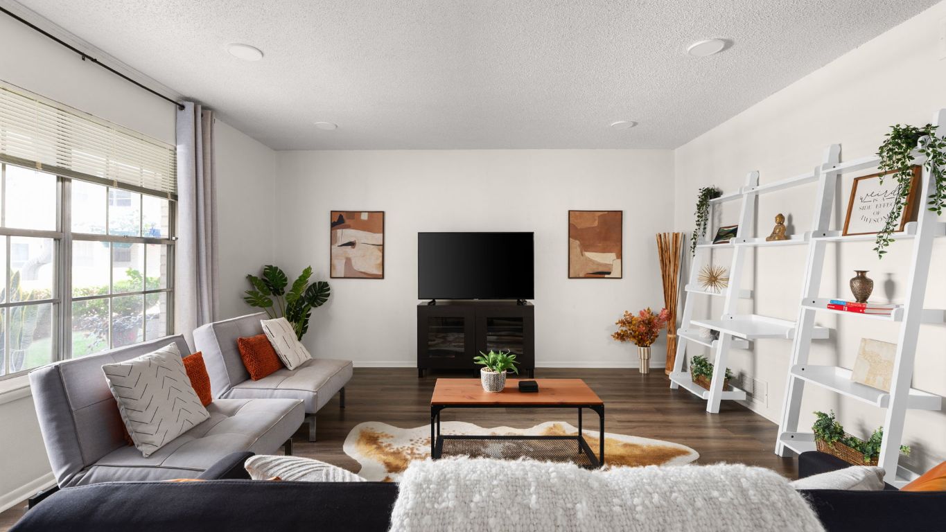 a living room with furniture fireplace and a flat screen tv