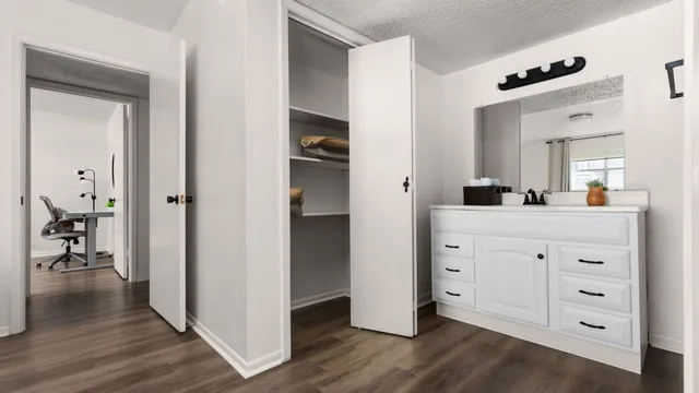 a hall with cabinets and wooden floor
