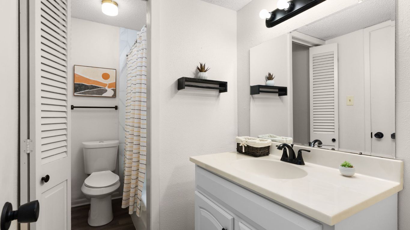 8730 North Mopac Expressway, Unit 109 Austin, TX 78759 - Photo 14 of 21 a bathroom with a toilet sink and mirror