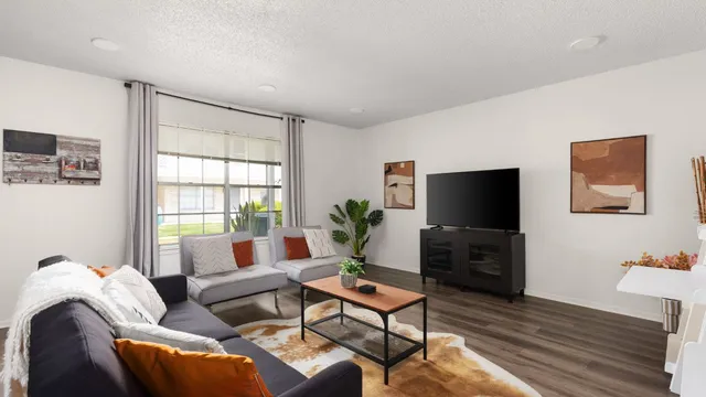 a living room with furniture and a flat screen tv