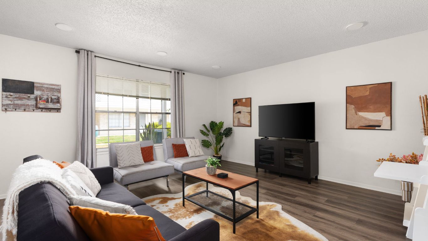 8730 North Mopac Expressway, Unit 109 Austin, TX 78759 - Photo 2 of 21 a living room with furniture and a flat screen tv