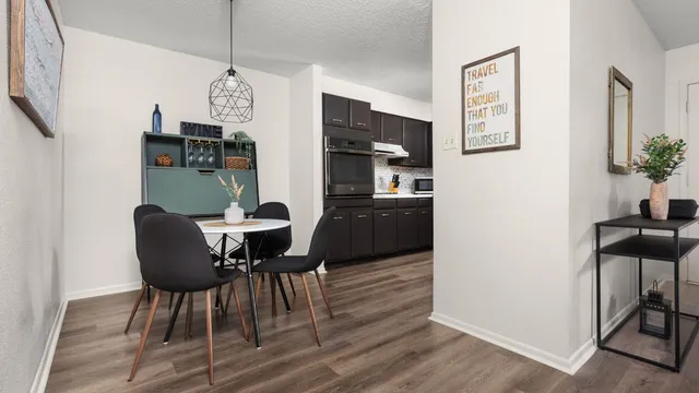 a dining room with furniture and wooden floor