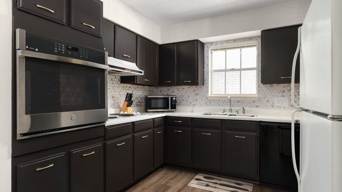 8730 North Mopac Expressway, Unit 109 Austin, TX 78759 - Photo 6 of 21 a kitchen with a sink a window and stainless steel appliances