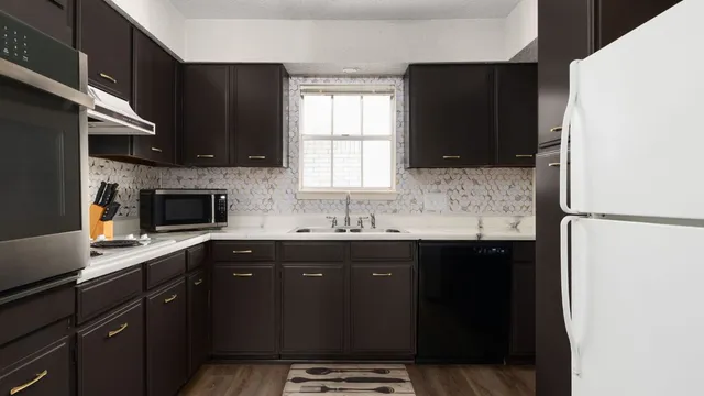 a kitchen with a sink a window and appliances