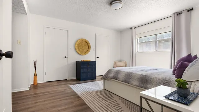 a bedroom with a bed and a window