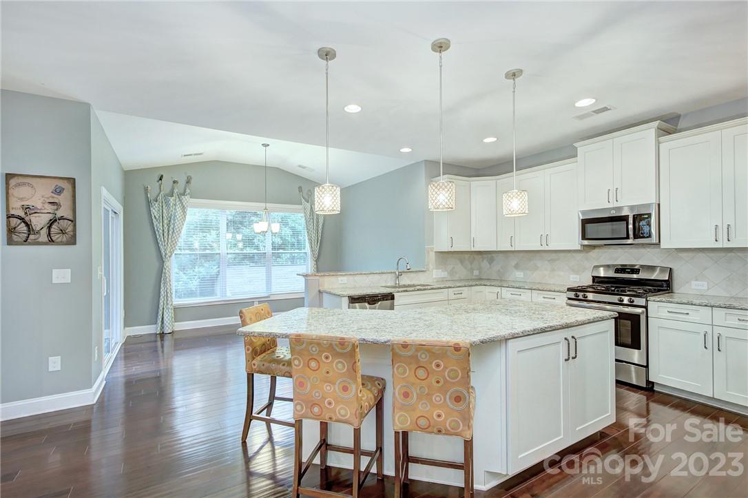 160 Kentmere Lane Clover, SC 29710 - Photo 5 of 37 a kitchen with stainless steel appliances granite countertop a stove a sink refrigerator and a wooden cabinets