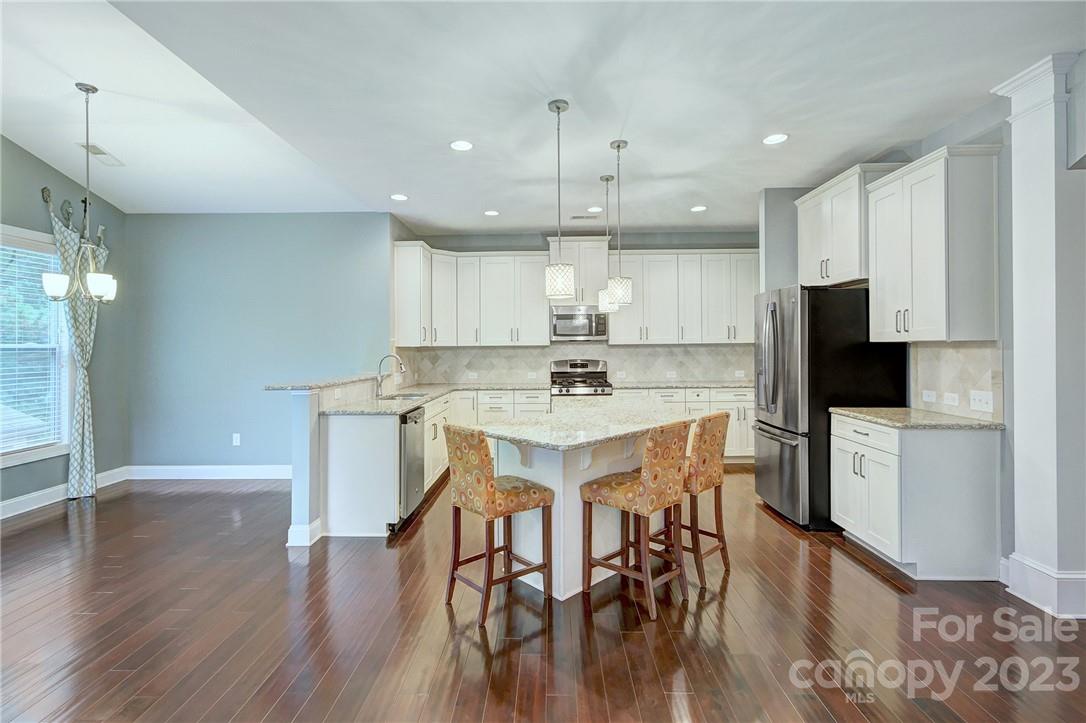 160 Kentmere Lane Clover, SC 29710 - Photo 6 of 37 a kitchen with a table chairs refrigerator and cabinets