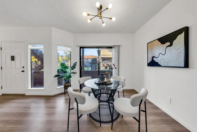 a dining room with furniture window and wooden floor