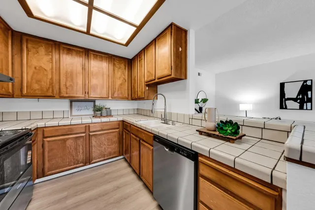 a kitchen with stainless steel appliances granite countertop a stove a refrigerator and a microwave