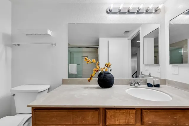 a bedroom with a bed and a potted plant