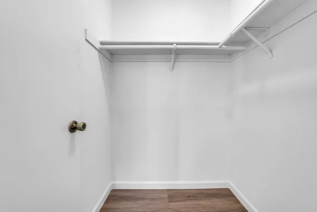 a bedroom with a bed and a desk