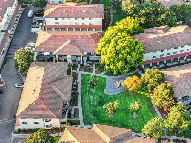 an aerial view of residential houses with outdoor space