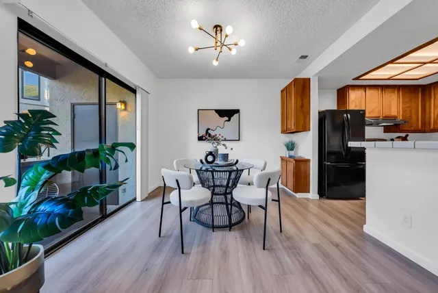 a view of a dining room with furniture and wooden floor