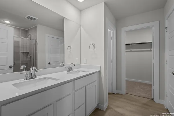 a bathroom with a sink double vanity and a mirror