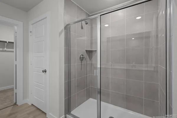 a bathroom with a shower and a sink