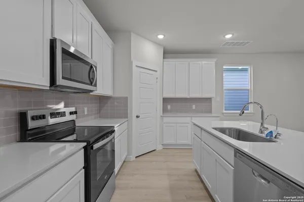 a kitchen that has a sink and a stove