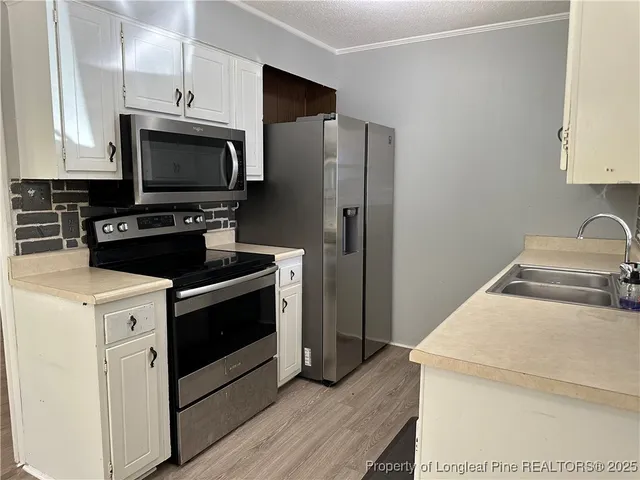 a kitchen with a stove microwave and refrigerator
