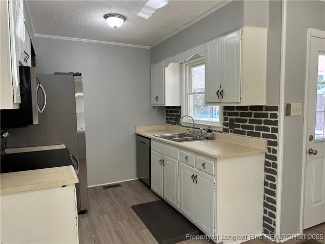 a view of a kitchen with electric appliances